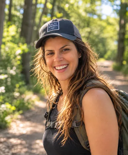 Elle, smiling on a wooded trail
